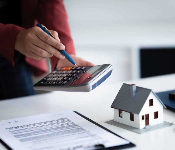 financial expert reviews house contract and loan calculation in office